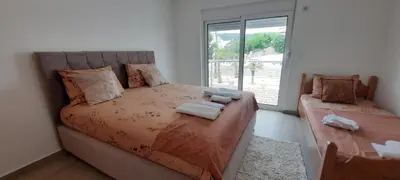 a bedroom with a bed with towels on it at Studio Apartments Jupo in Ulcinj