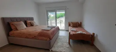 a bedroom with a bed and a window at Studio Apartments Jupo in Ulcinj