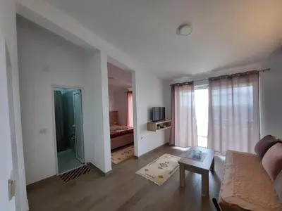 a living room with a couch and a window at Studio Apartments Jupo in Ulcinj