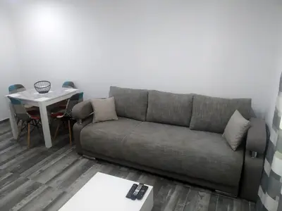 a living room with a couch and a table at Take a Lake - Zabes, Virpazar in Virpazar