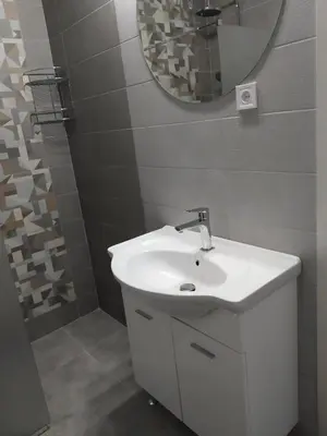 a bathroom with a white sink and a mirror at Take a Lake - Zabes, Virpazar in Virpazar