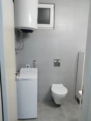 a white bathroom with a toilet and a sink at Take a Lake - Zabes, Virpazar in Virpazar