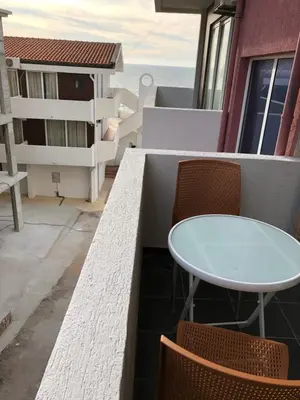 a balcony with a table and chairs and the ocean at Apartments Atlantis in Dobra Voda