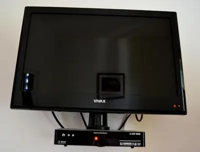 a flat screen tv sitting on top of a stand at Apartments Atlantis in Dobra Voda