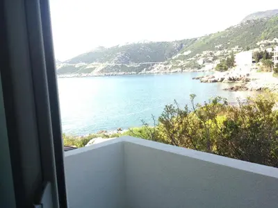 a view of a body of water from a balcony at Apartments Atlantis in Dobra Voda