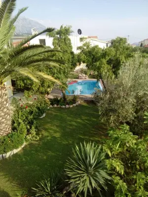 a garden with a swimming pool in a house at Garden in Bar