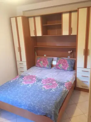 a bedroom with a bed with pink roses on it at Garden in Bar