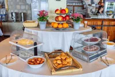 a table filled with lots of different types of food at Hotel Savojo in Petrovac na Moru