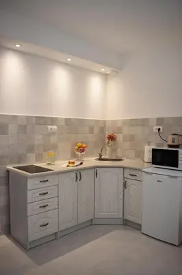 a kitchen with white cabinets and a white appliances at Art Apartments in Kotor