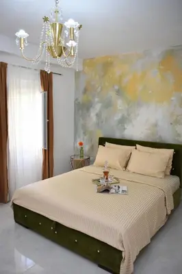 a bedroom with a large bed with a chandelier at Art Apartments in Kotor