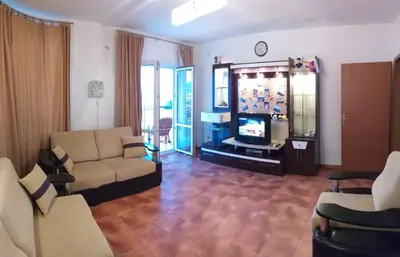 a living room with a couch and a television at Бар Шушань Апартаменты Главановича 25 in Bar
