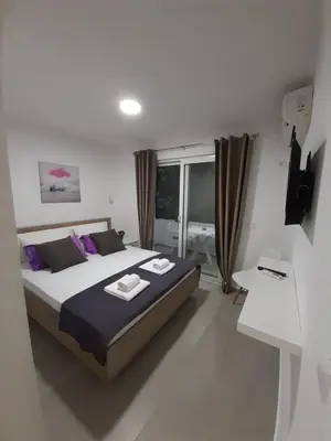 a bedroom with a bed with two towels on it at Apartman Danilo in Ulcinj