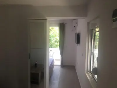 a hallway with a room with a bed and a window at Apartman Danilo in Ulcinj