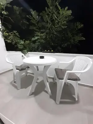 a white table and two chairs and a white table and chairs at Apartman Danilo in Ulcinj