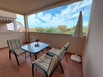 a balcony with a table and chairs and a window at One bedroom apartment Ljilja in Sveti Stefan
