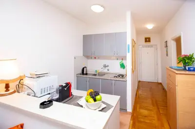 a kitchen with a counter with a bowl of fruit on it at One bedroom apartment Ljilja in Sveti Stefan