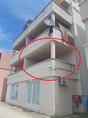 a red circle on the side of a building at One bedroom apartment Ljilja in Sveti Stefan