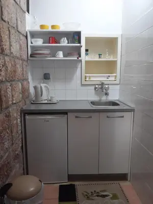 a small kitchen with a sink and a counter at Apartments StellaMar in Sveti Stefan