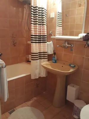 a bathroom with a sink and a tub and a toilet at Apartments StellaMar in Sveti Stefan