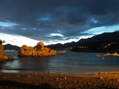 a group of rocks in the water on a beach at Apartments StellaMar in Sveti Stefan