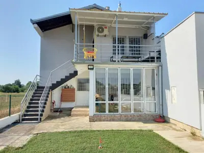 a house with glass doors and a basketball hoop on the balcony at Liza Apartment in Ulcinj