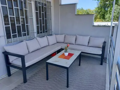 a couch and a coffee table on a balcony at Liza Apartment in Ulcinj