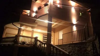 a building with a staircase with lights on it at Lakeview Apartments Anđela in Virpazar