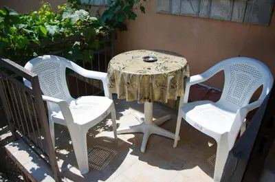a table and two chairs sitting next to a table with at Studio-apartman Milena in Podgorica