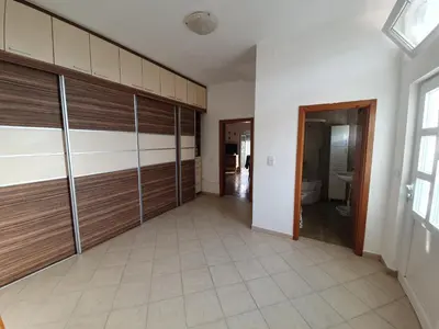 a room with wooden garage doors and a tile floor at Feel the village in Virpazar