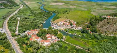 an aerial view of a house with a river at Feel the village in Virpazar