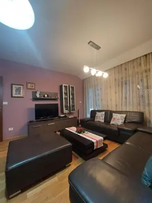 a living room with a couch and a tv at Apartman Sara 2 in Podgorica