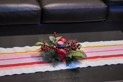 a table topped with a flower arrangement on a table at Apartman Sara 2 in Podgorica