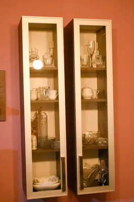 a cabinet filled with glasses and dishes in a room at Apartman Sara 2 in Podgorica