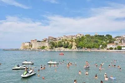 a group of people in the water at a beach at Apartments Aleksandar in Ulcinj