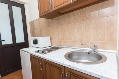 a kitchen with a sink and a microwave at Apartments Aleksandar in Ulcinj