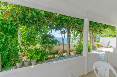 a room with a window with a view of the ocean at Apartments Aleksandar in Ulcinj
