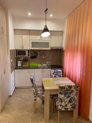 a kitchen with a wooden table and two chairs at Villa Lili in Kotor