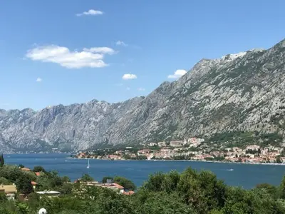 a large body of water next to a mountain at Villa Lili in Kotor