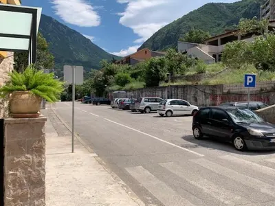a parking lot with cars parked on the side of a street at Villa Lili in Kotor
