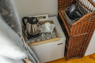 a tea kettle and a tea pot on top of a refrigerator at Le Petit Chateau in Bar