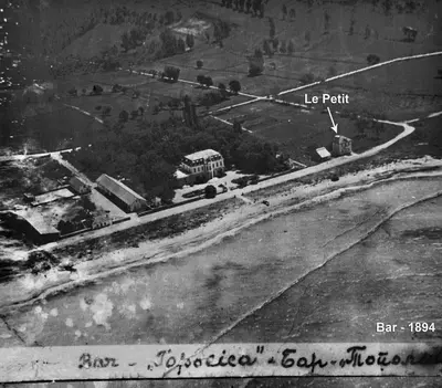 a black and white photo of a street with a bus at Le Petit Chateau in Bar