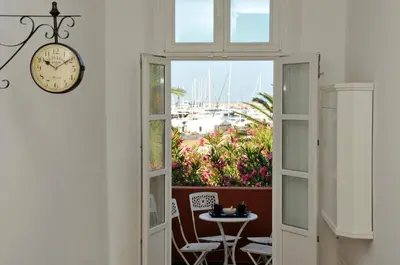 a clock on a wall next to a door with a table at Le Petit Chateau in Bar