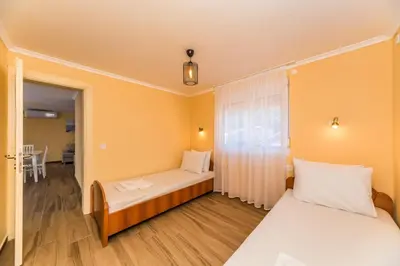 a small room with two beds and a window at Apartments Sole Mar in Sutomore