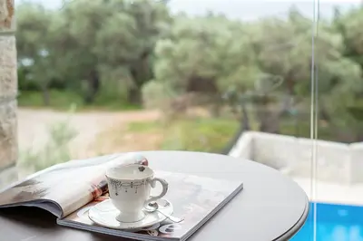 a coffee cup and a book on a table at Adria lux apartmens 2 in Sveti Stefan