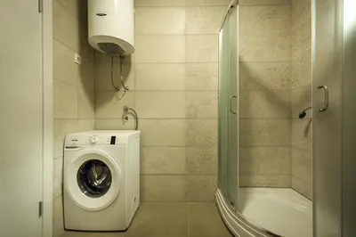 a bathroom with a washing machine and a shower at Adria lux apartmens 2 in Sveti Stefan