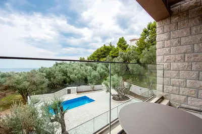 a balcony with a view of a swimming pool at Adria lux apartmens 2 in Sveti Stefan