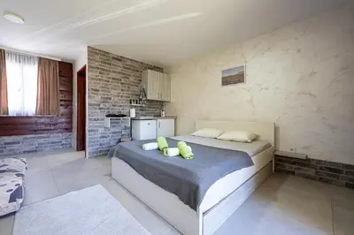 a bedroom with a bed with two pillows on it at Apartments Obala in Podgorica