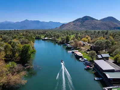 a boat is in the water on a river at Apartments Obala in Podgorica