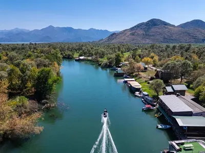 a boat is in the water on a river at Apartments Obala in Podgorica