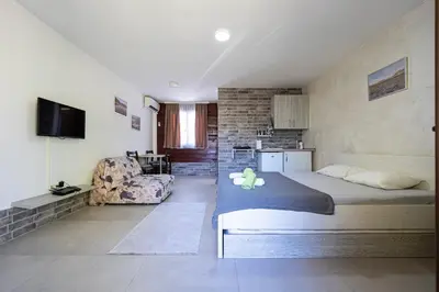 a bedroom with a bed with a teddy bear on it at Apartments Obala in Podgorica